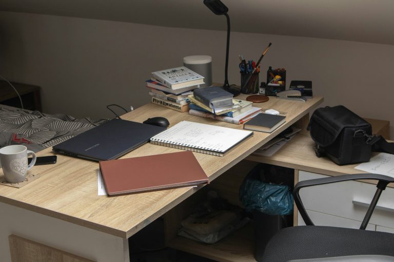 A wooden desk topped with a laptop computer
